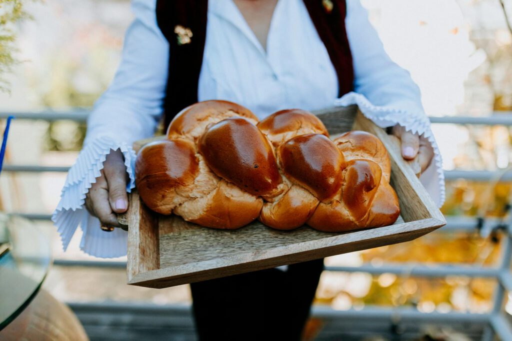 Close-Up Photo Of Person Holding A Tray Of Freshly Baked Bread