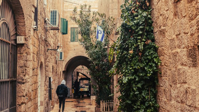 a man walking down a narrow alley way