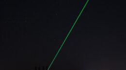 city buildings near body of water during nighttime