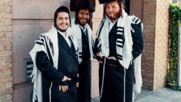 2 men in black and white coat standing on gray concrete floor