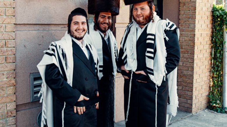 2 men in black and white coat standing on gray concrete floor
